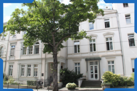 Fassade vom Haus der Krebs-Selbsthilfe, davor ein Baum