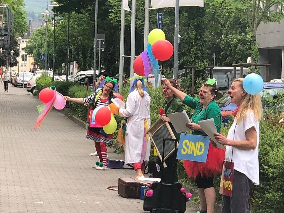Die Westerwälder Clowns stehen in einer Fußgängerzone.